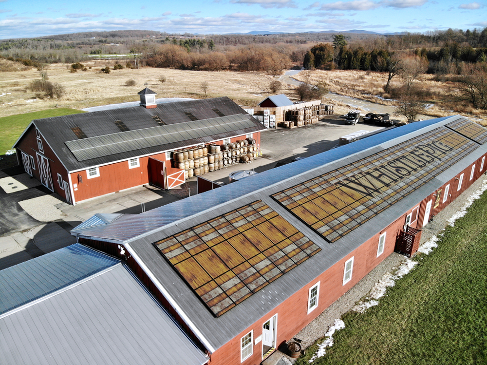 Final install showcasing WhistlePig branding on front roof and metal roof accent on back warehouse roof