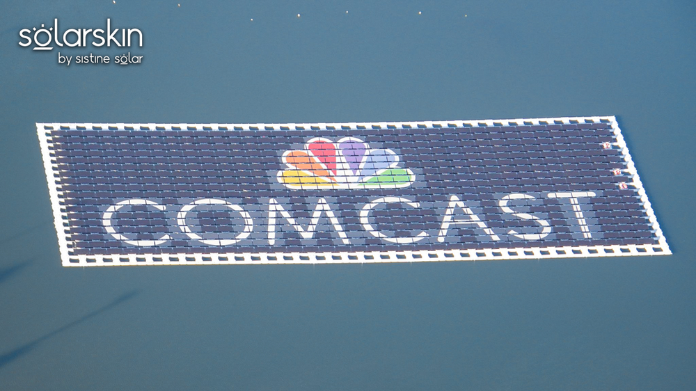 Close-up: Floating solar array equipped with SolarSkin™ — photo credit: @bioreconstruct on Twitter Comcast logo powered by SolarSkin on floating solar array