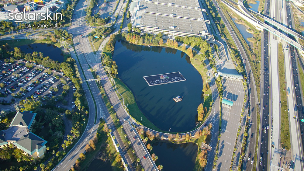 Aerial view: Floating solar array equipped with SolarSkin™ — photo credit: @bioreconstruct on Twitter Comcast logo powered by SolarSkin on floating solar array